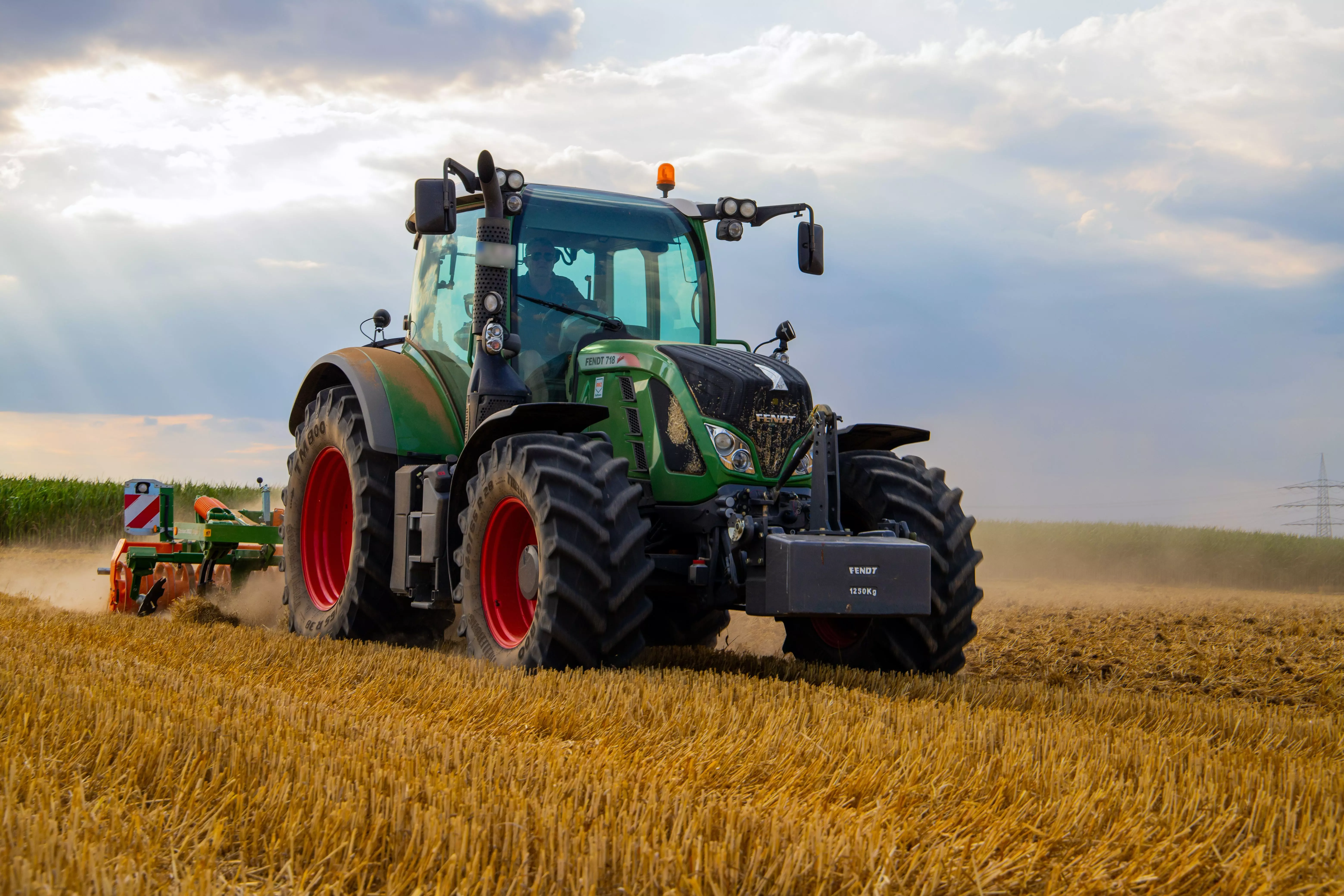 AnyConv.com__large green tractor running a plough through a corn field AnyConv.com__large green tractor running a plough through a corn field