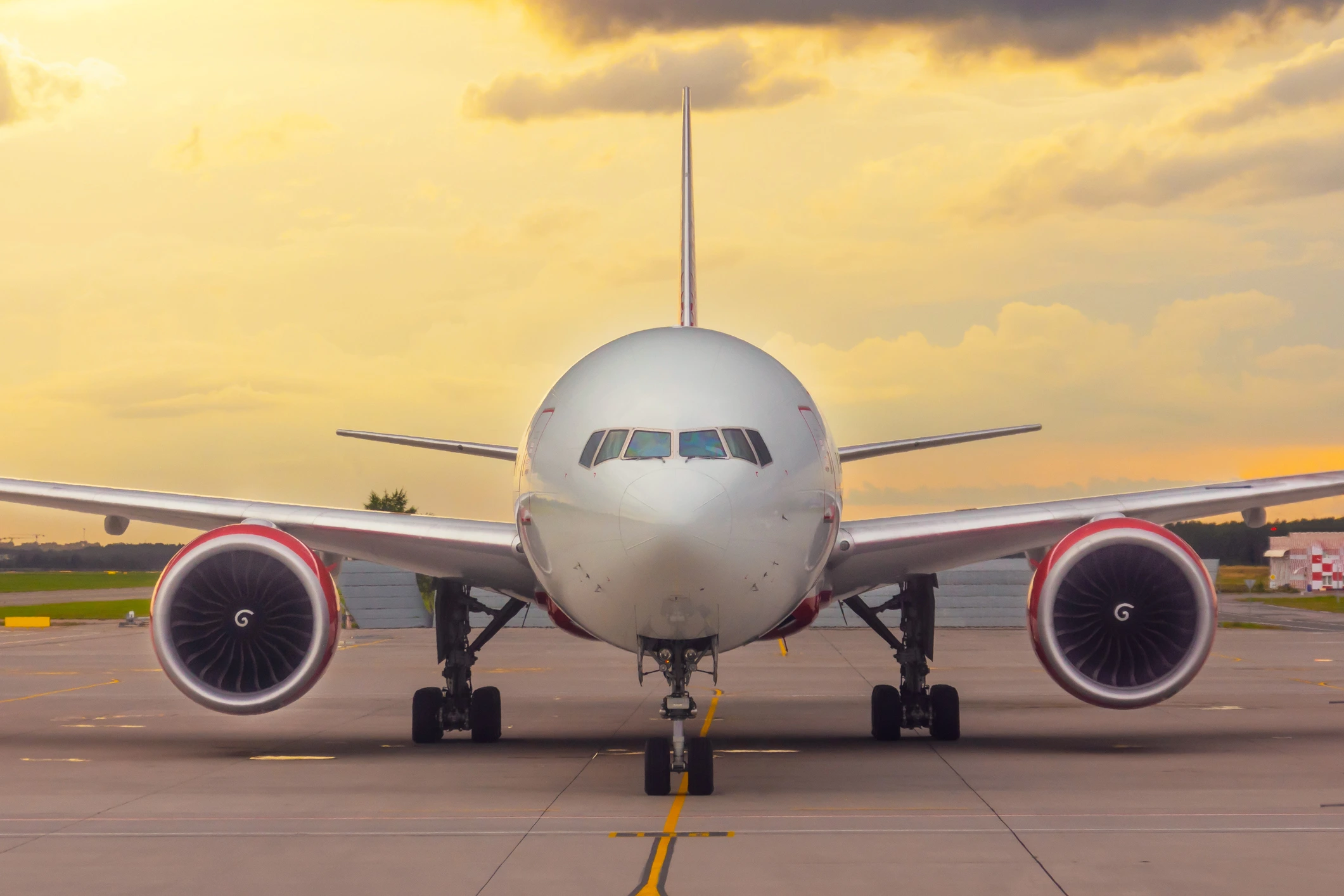twin engine airplane sitting on runway in front of a sunset twin engine airplane sitting on runway in front of a sunset